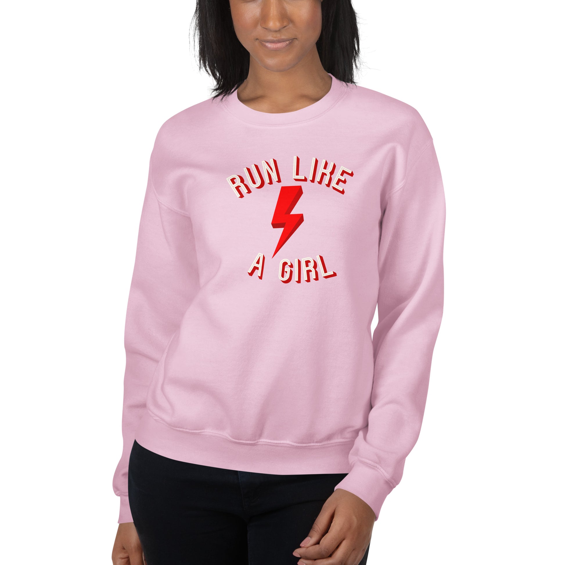 woman wearing a light pink sweatshirt with the words 'run like a girl' in a white and red font, wrapped around a red lightening bolt