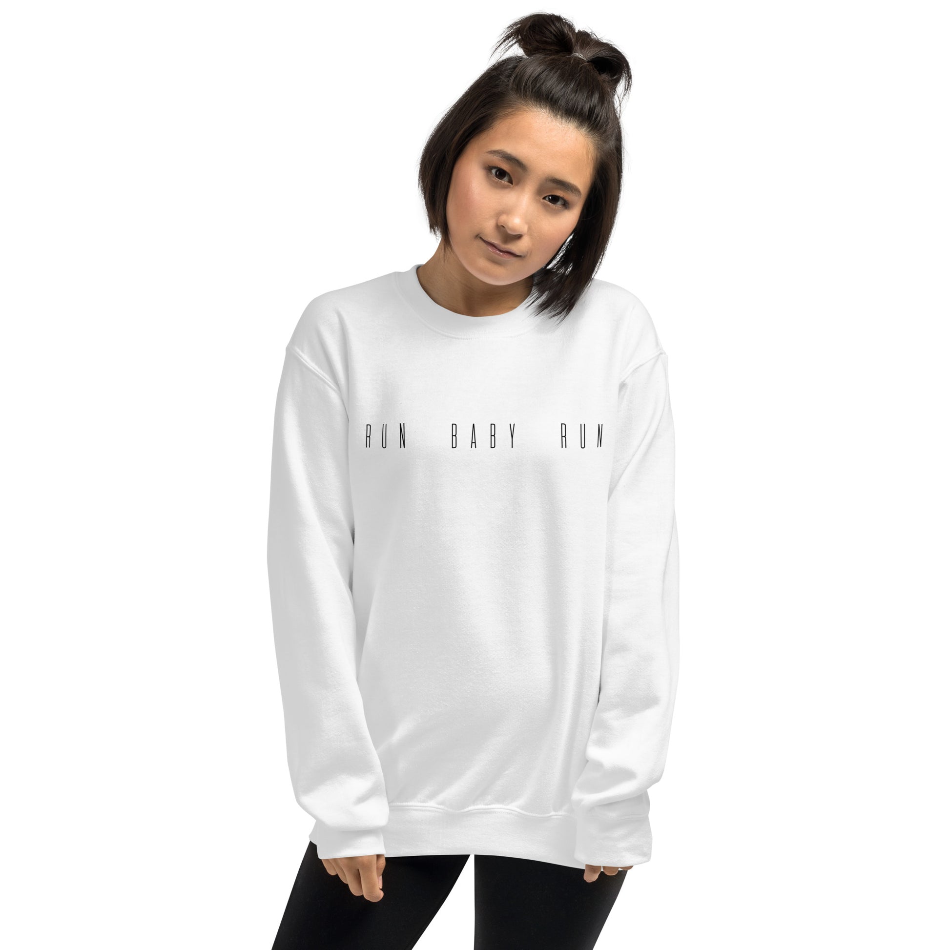woman wearing a white sweatshirt with the words run baby run across the chest