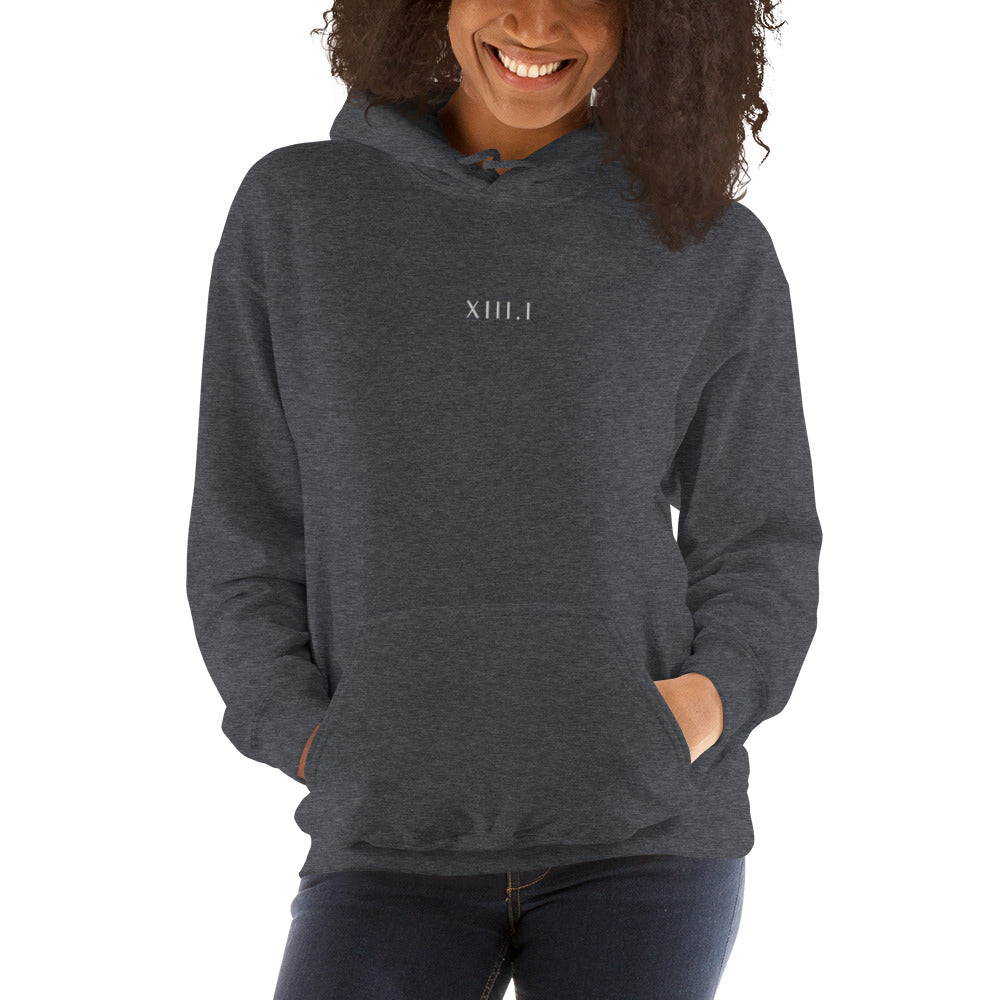 woman wearing a dark grey unisex hoodie with XIII.I 13.1 half marathon in roman numerals embroidered in white writing