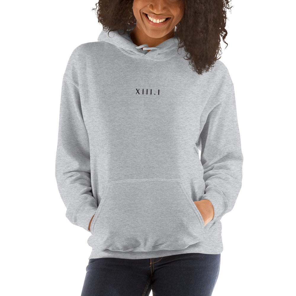 woman wearing a grey unisex hoodie with XIII.I 13.1 half marathon in roman numerals embroidered in black writing