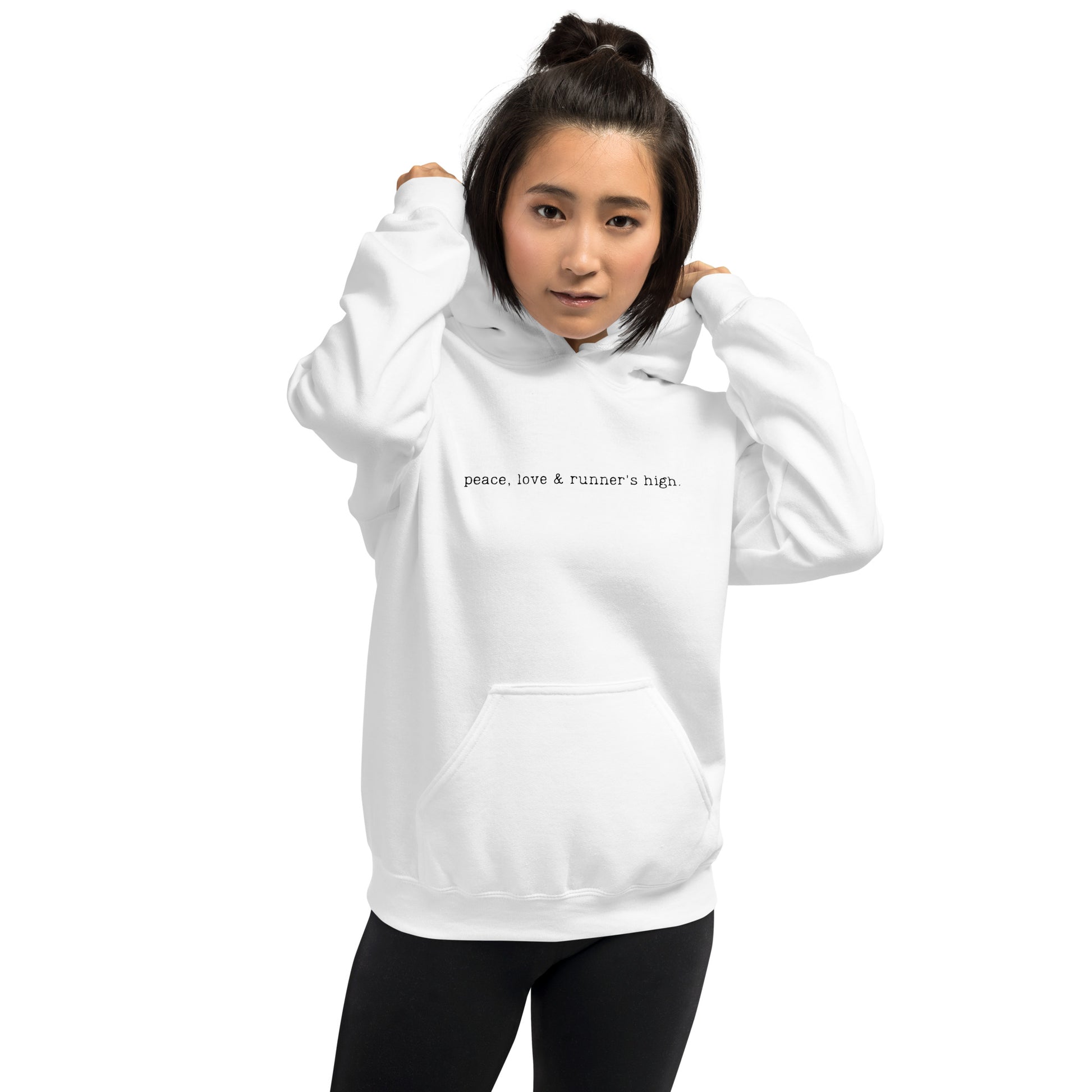 woman wearing a white hoodie with the words peace, love and runners high across the chest
