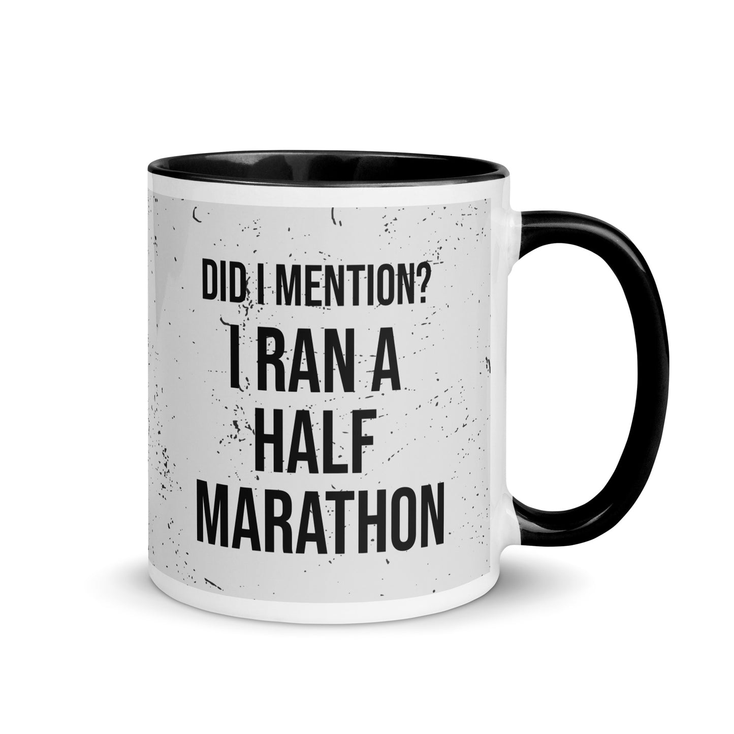 black handled mug with the words did I mention? I ran a half marathon in a bold font across a splatter effect background