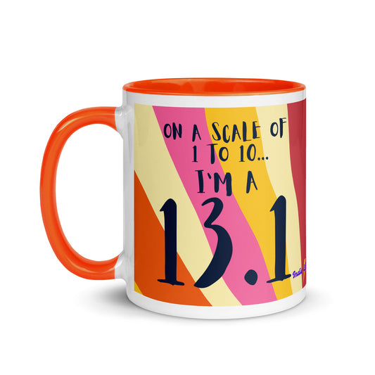orange rimmed and handled mug with a colourful sun ray style design and the words on a scale of 1 to 10 I'm a 13.1. A gift for half marathon runners
