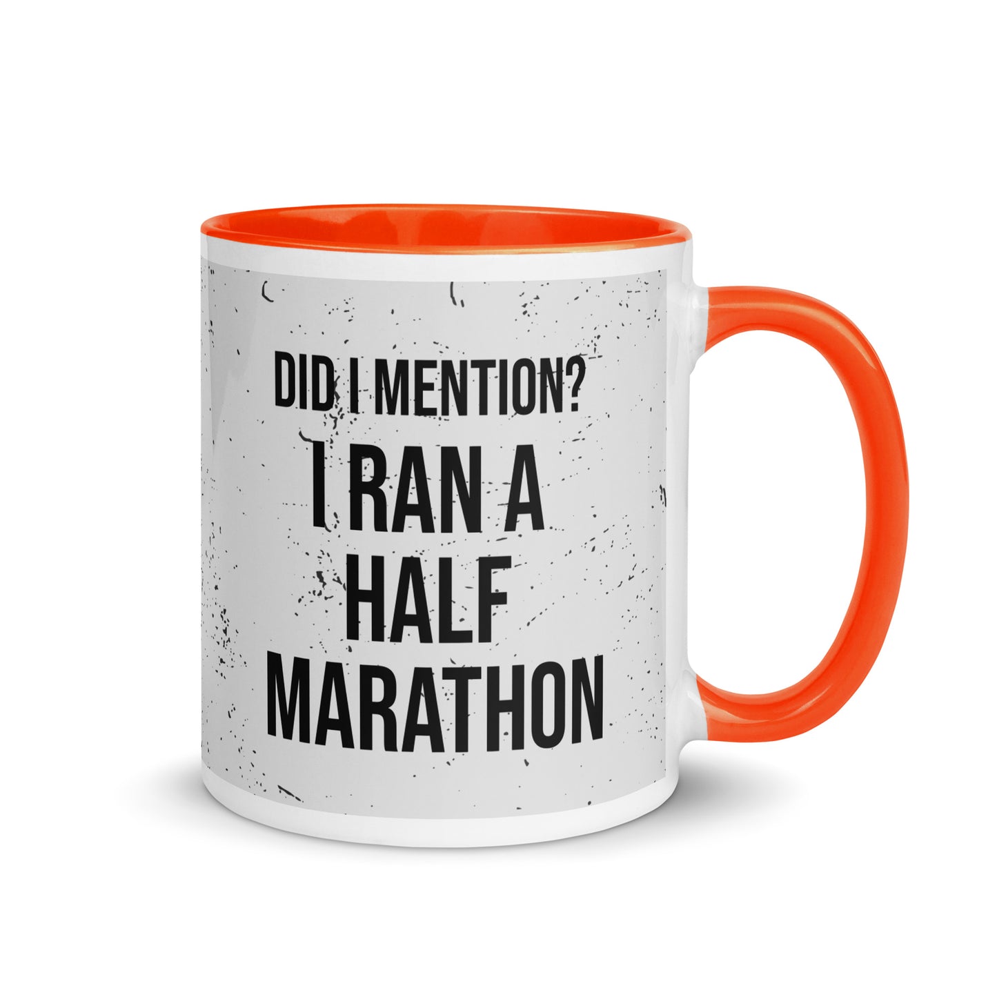 orange handled mug with the words did I mention? I ran a half marathon in a bold font across a splatter effect background