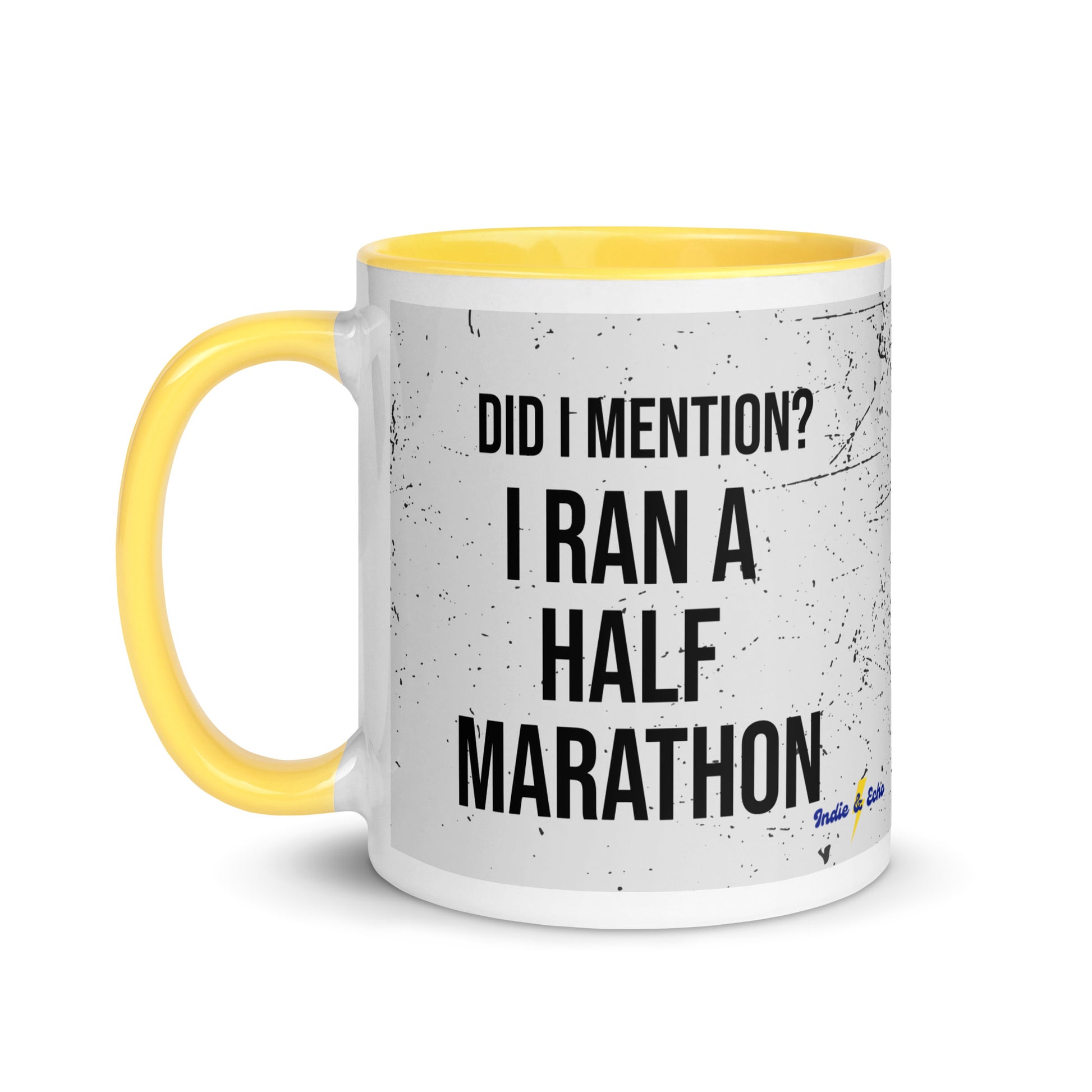 yellow handled mug with the words did I mention? I ran a half marathon in a bold font across a splatter effect background
