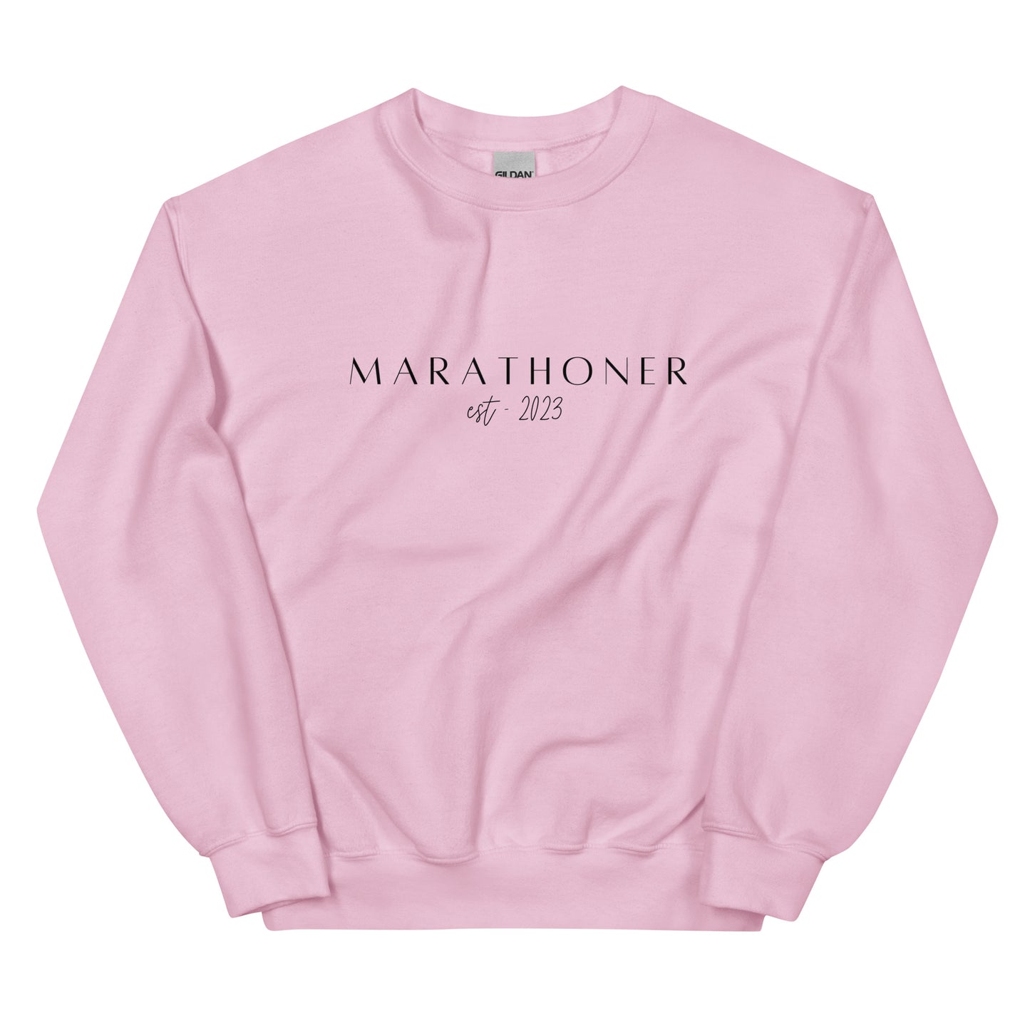 pink sweatshirt with the words Marathoner est 2023 across the chest