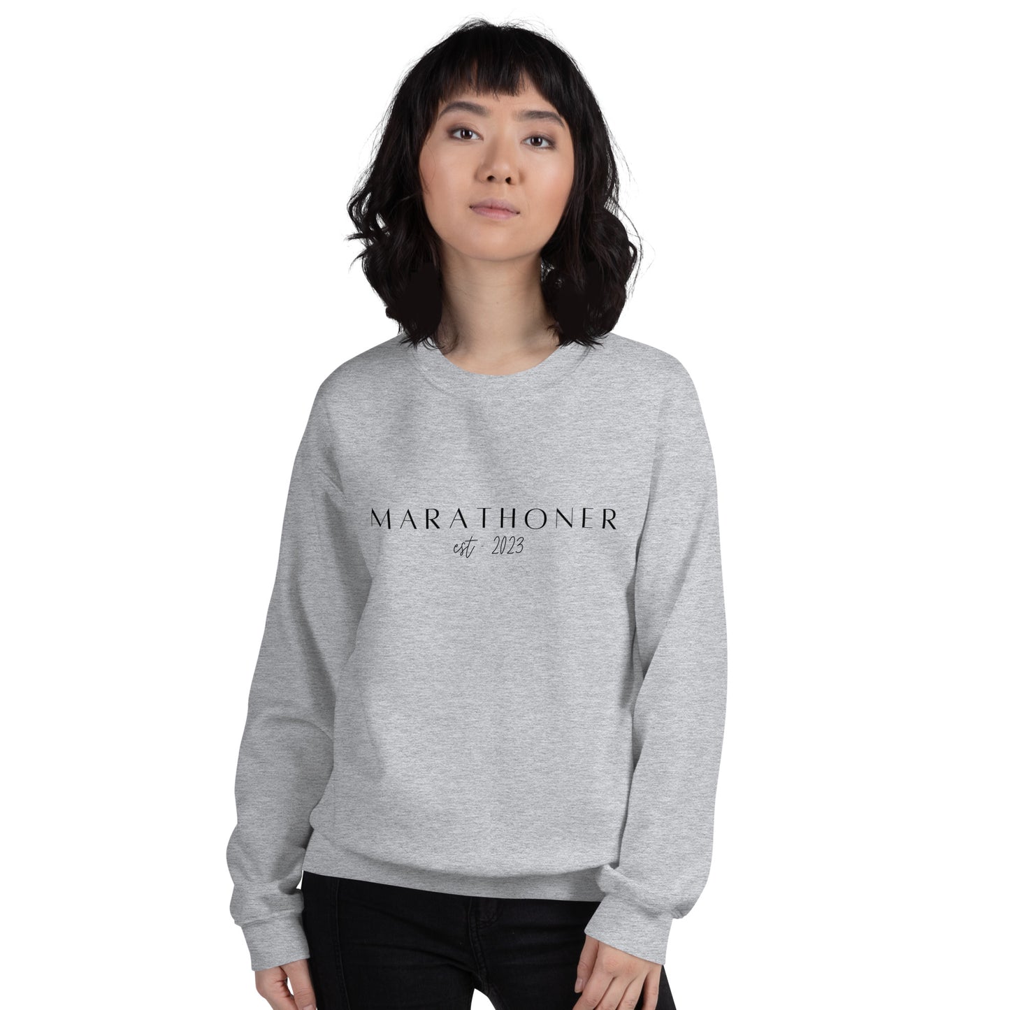 woman wearing a grey sweatshirt with the words Marathoner est 2023 across the chest