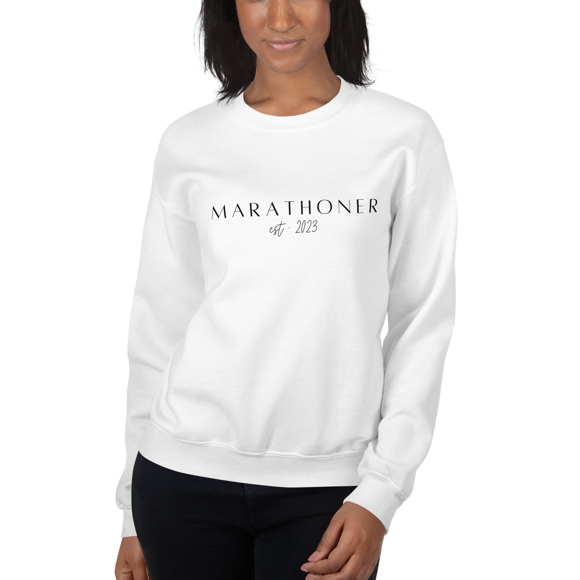 woman wearing a white sweatshirt with the words Marathoner est 2023 across the chest