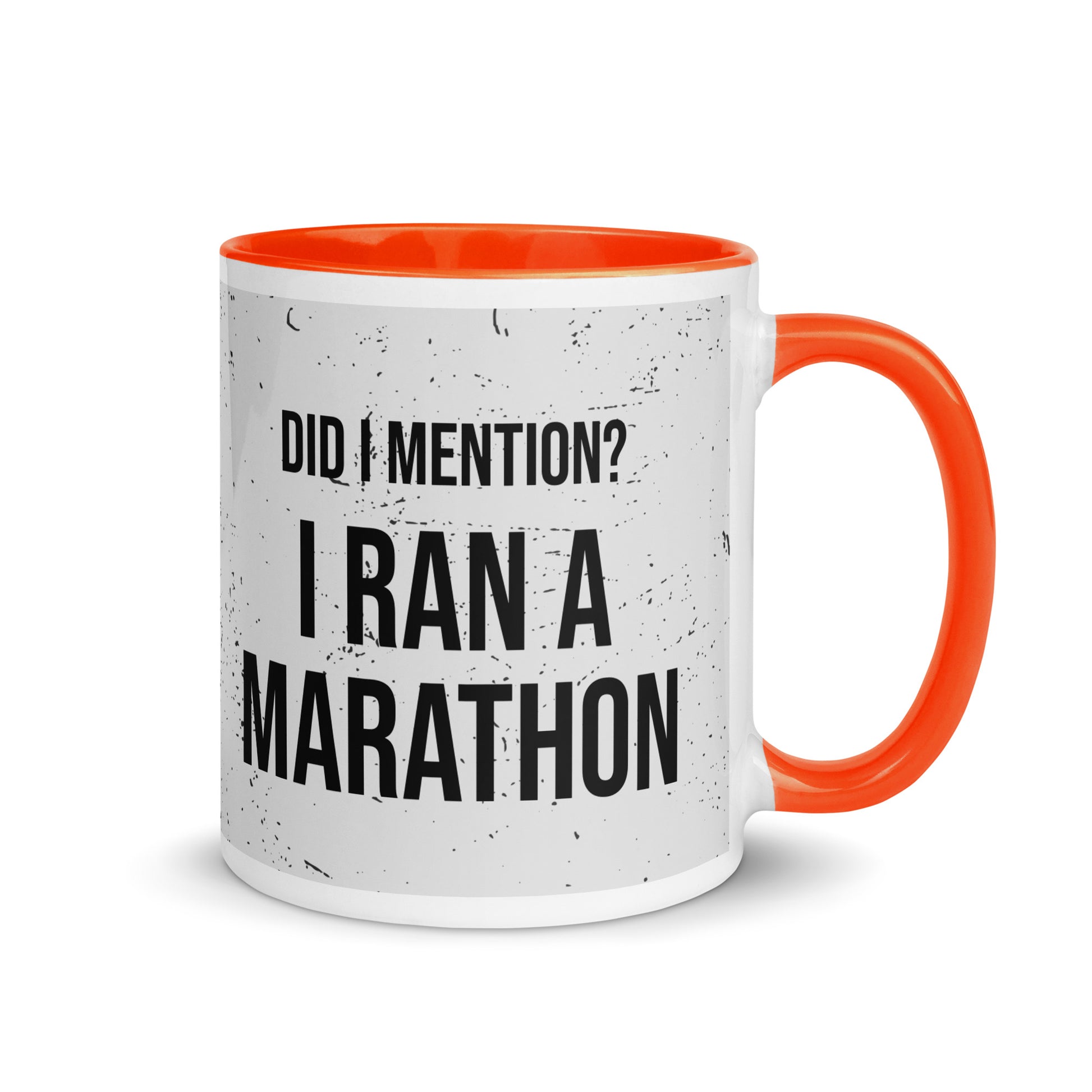 orange handled mug with an ink splatter design, and the words did i mention? I ran a marathon in a capitalised, bold black font. 